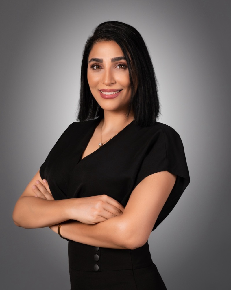 Dr. Hasti Jamshidi standing with arms crossed
